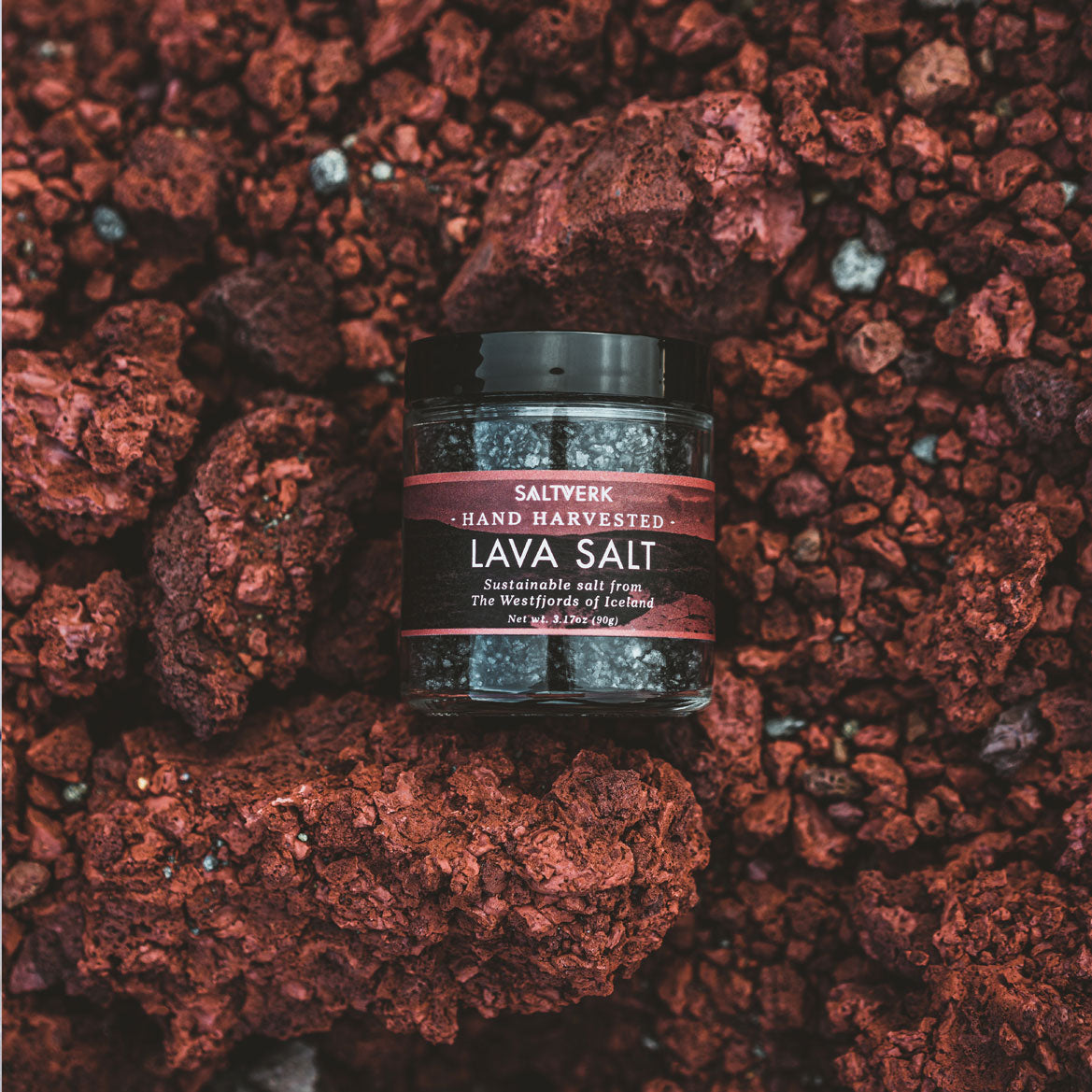 Icelandic Lava Salt placed in a stunning Icelandic landscape with volcanic rocks, highlighting the pure and natural essence of this premium sea salt
