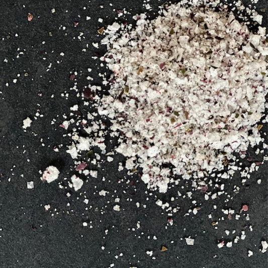 Icelandic seaweed salt scattered on a surface, showcasing the texture and rich umami flavor of Saltverk's seaweed-infused sea salt